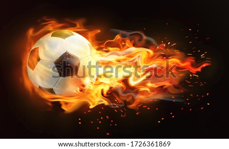 Soccer ball with bright flame flying on black background