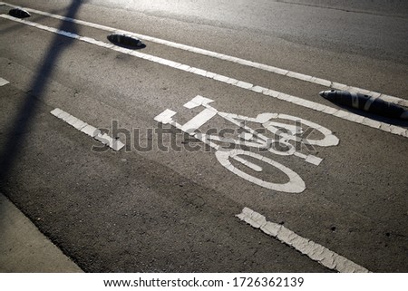 Bike lane sign painted on a street in Zaragoza, Spain.
