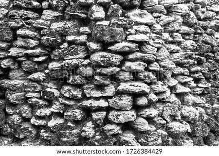 old mayan stone wall black and white