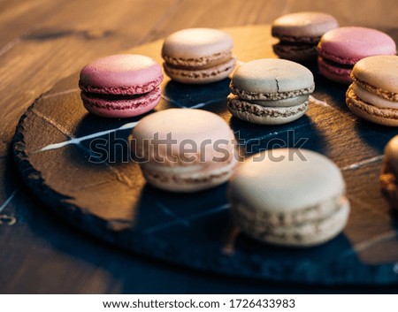 Several multicolored cookies on a dark surface