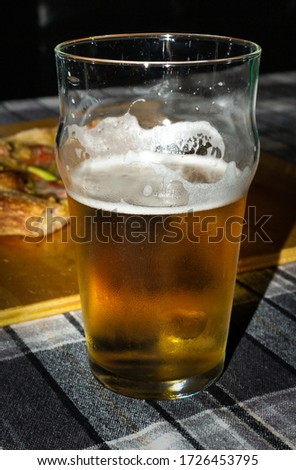 closeup of half-filled glass of beer