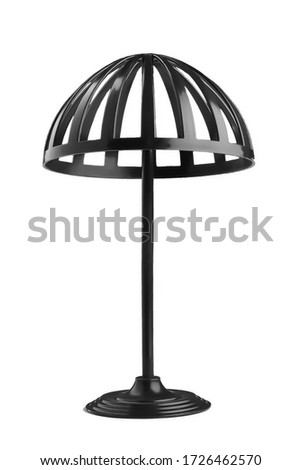 Subject shot of a black plastic stand for wigs and hats. The accessory for headwear care is isolated on a white background.   Royalty-Free Stock Photo #1726462570