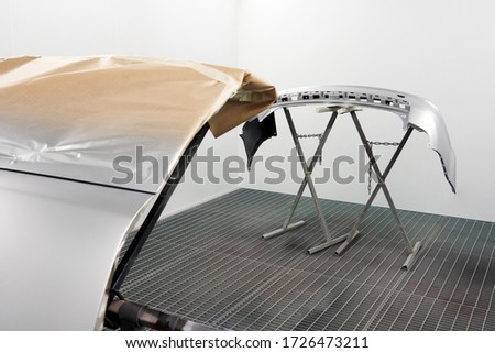 Car bumper after painting. Drying parts of the automobile in spray booth. Royalty-Free Stock Photo #1726473211