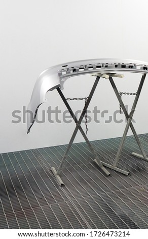 Car bumper after painting. Drying parts of the automobile in spray booth. Royalty-Free Stock Photo #1726473214