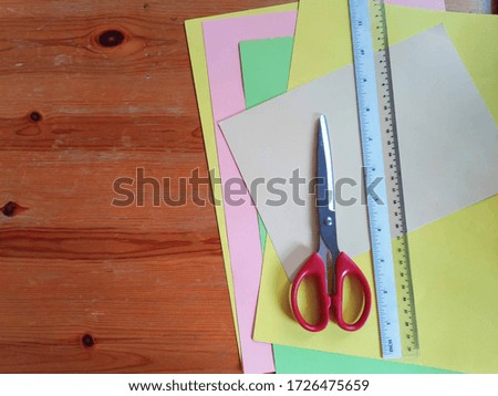 colored paper and scissors to create crafts in the classroom work at school, preparation for school