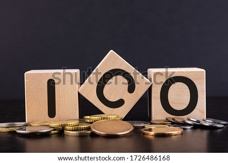 ICO The initial offer of coins is written on wooden cubes. Gold coins are scattered in the center.