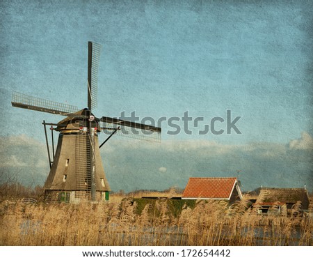 View of windmill at Kinderdijk, Netherlands. Photo in retro style. Added paper texture.