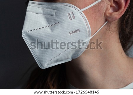 Young woman wearing KN-95 protection medical mask. Prevention of the spread of virus and epidemic, protective mouth filter mask. Diseases, flu, air pollution, corona virus concept Royalty-Free Stock Photo #1726548145