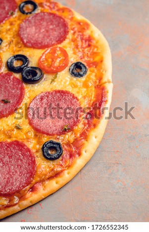 Fresh pepperoni pizza served on the rustic background. Selective focus. Shallow depth of field.