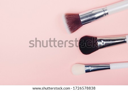 Set kit makeup brushes on pink background, copy space.