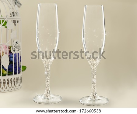 Two fancy wedding goblets glasses on tender background