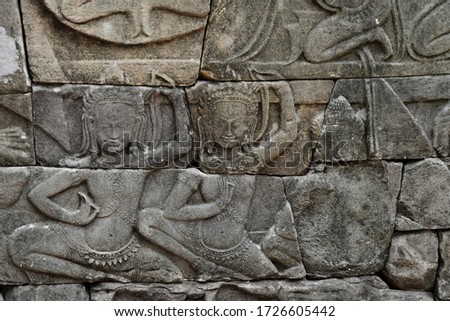 Wall relief of 32 armed Vishnu and attendants at the ruins of Banteay Chhmar in the remote North West region of Cambodia