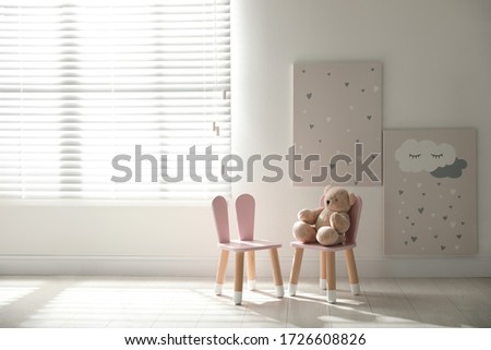 Cute chairs with bunny ears in children's room interior