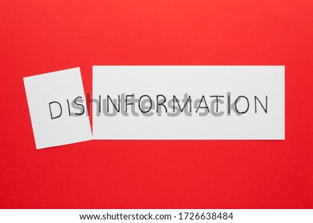 Changing the word disinformation to information on a white sheet Royalty-Free Stock Photo #1726638484