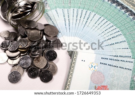 Malaysia Ringgit note and coins isolated on white background. Business and financial concept. Selective focus. Copy space.