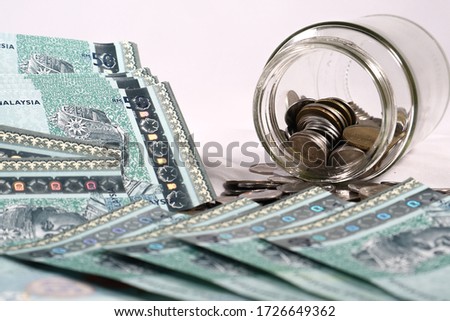 Malaysia Ringgit note and coins isolated on white background. Business and financial concept. Selective focus. Copy space.