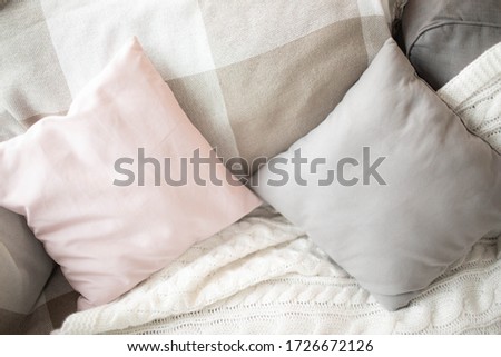 Small square pillows on the sofa. Close up.