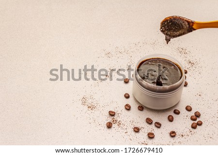 Spa concept. Self care with coffee body scrub. Natural organic cosmetics, homemade product, alternative lifestyle. White putty background Royalty-Free Stock Photo #1726679410
