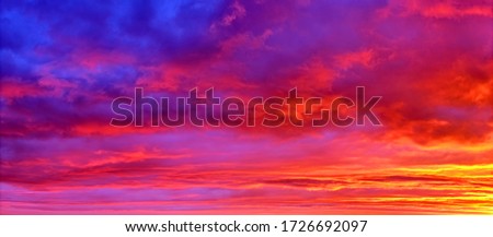 mellow sunset sky landscape background natural color of evening cloudscape panorama with sun below horizon ultra wide panoramic view of Red orange and blue colors of evening nature Royalty-Free Stock Photo #1726692097