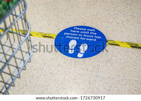 CORBY/ENGLAND- 7 MARCH 2020: Social distancing floor sticker in Tesco in Corby, during the Coronavirus 2020 lockdown Royalty-Free Stock Photo #1726730917