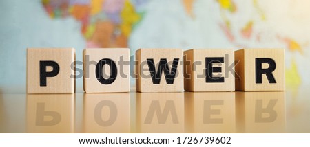 The word power written on wooden cubes isolated on a political map background