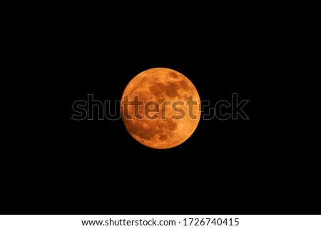 The yellow full moon on black background
