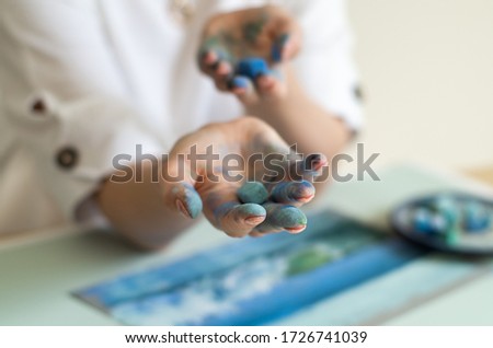 Female artist holds pastel chalk in her hands