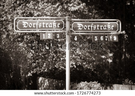 in a German village there is a street sign with the inscription Dorfstrasse in old letters