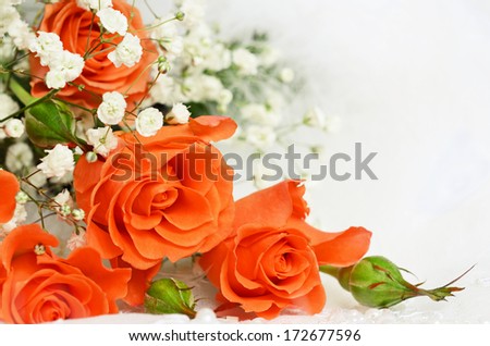 Orange roses on white wedding lace