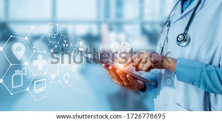 Medicine doctor touching tablet with  digital healthcare and network connection and hologram modern virtual screen interface icons, Medical technology and futuristic concept.