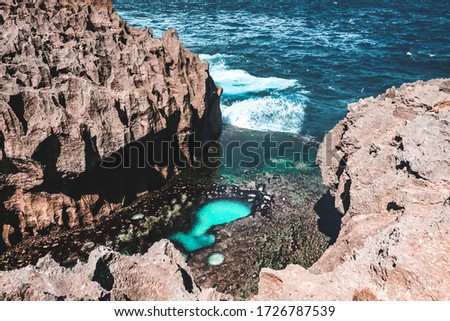 Stone indentation with turquoise water