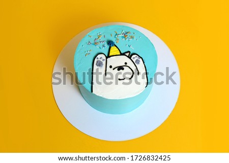 funny birthday cake with a bear on yellow background