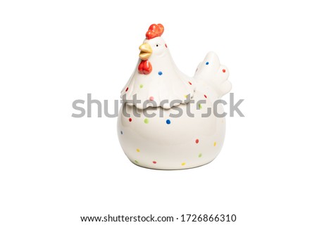 White ceramic rooster figurine with colored dots on body feathers isolated on white background. Concept of home decoration, happy Easter, year of cock.