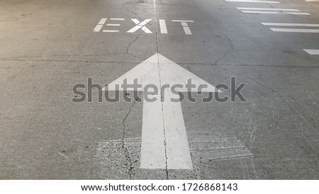 Exit sign on the driveway in parking garage