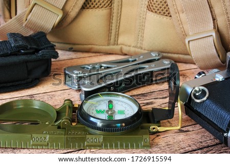 A compass and a backpack for a hike