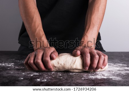 Close-up of male baker kneading the dough	