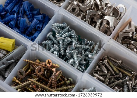Close up of screw box with screws and dowels of different sizes and measures