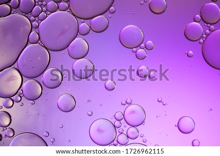Colorful artistic of oil drop floating on the water. Abstract oil bubbles background. Macro shot. oil bubbles close up. water bubbles. Bright and unique oil drops, circles on the water surface.