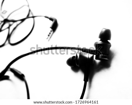 Black modern headphones with a headset on a light gray background. concept of digital music