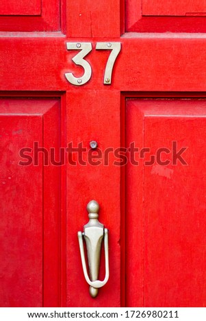 House number 37 on a red wooden front door
