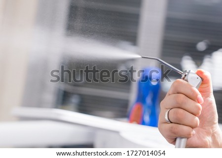 Dentistry, dental health and medicine concept - Close-up of dentist's hand holding a dental tool instrument. Royalty-Free Stock Photo #1727014054