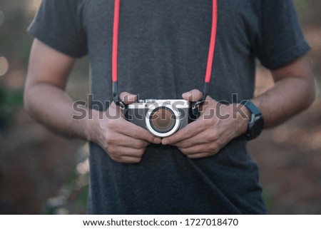 close up of photographer holding camera to take a photo