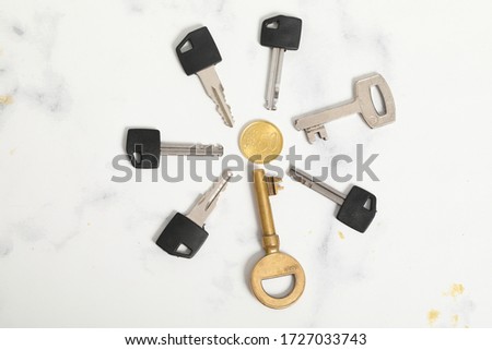 A pair of keys isolated on white marble background