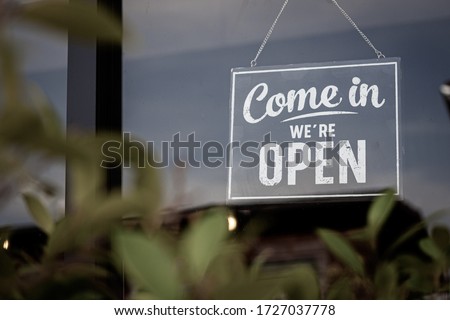 Come in we're open, vintage black retro sign in store front Royalty-Free Stock Photo #1727037778