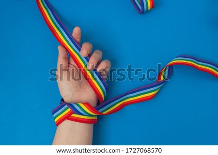 LGBT rainbow ribbon on blue background. Concept of thanks to doctors during a pandemic and hope