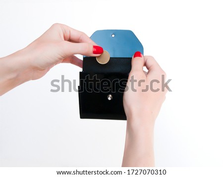 woman hands put a coin in a wallet