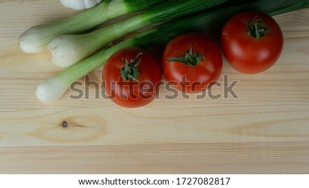 
Vegetables and pizza preparation products on a wooden table. Free space for text.