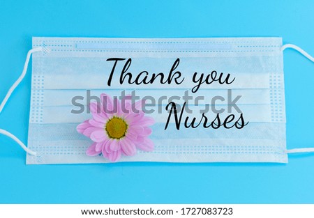 protective facial medical mask with a flower on a blue background and text Thank you nurses who are frontline workers during the coronavirus pandemic