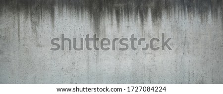 Horizontal picture of old and stained concrete wall with dripped water signs, suitable for backgrounds