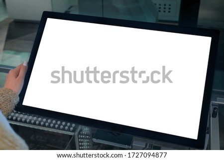 White screen, mock up, future, copyspace, template, isolated, technology concept. Woman looking at blank interactive touchscreen white display of electronic kiosk at futuristic exhibition or museum